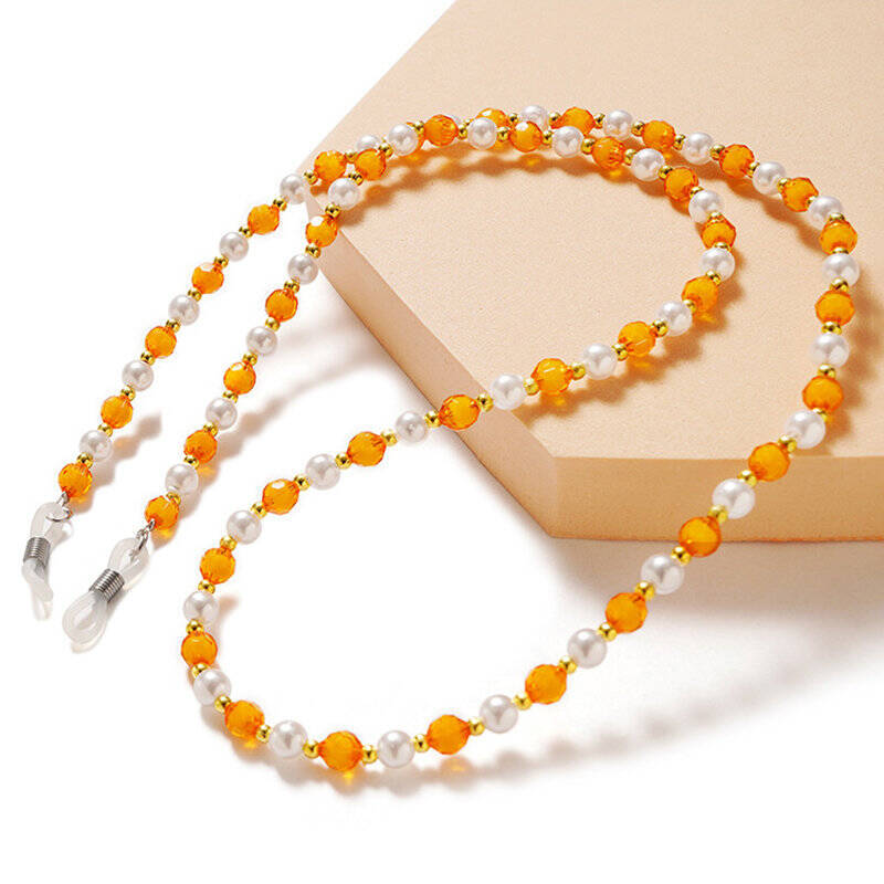 A CHAIN FOR GLASSES, BEADS, AN ORANGE PENDANT